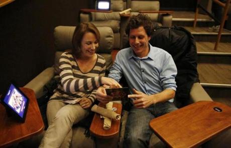 Globe reporter Ethan Gilsdorf (right) and Mary Ann Guillete tried out the seats at Showcase Superlux in Chestnut Hill.
